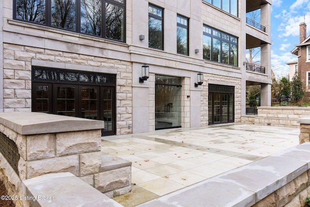 1576 Cherokee Rd Unit 1, Louisville, KY 40205 - property entrance with french doors, stone siding, a patio, and a balcony