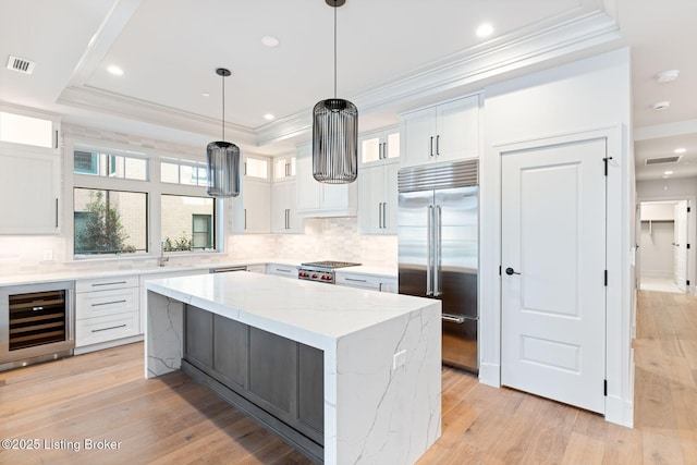 1576 Cherokee Rd Unit 1, Louisville, KY 40205 - kitchen with stainless steel built in fridge, beverage cooler, a tray ceiling, crown molding, and decorative backsplash