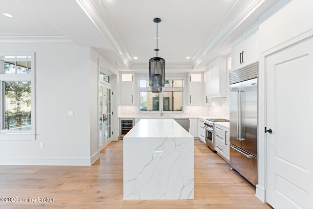 1576 Cherokee Rd Unit 1, Louisville, KY 40205 - kitchen featuring high end appliances, beverage cooler, a kitchen island, tasteful backsplash, and ornamental molding