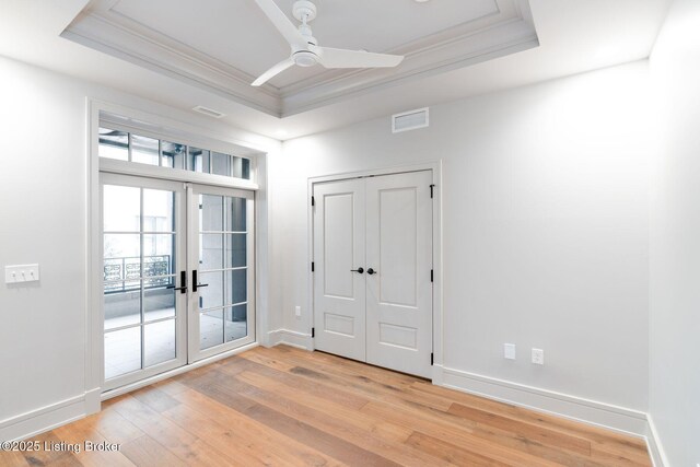 1576 Cherokee Rd Unit 1, Louisville, KY 40205 - doorway featuring a tray ceiling, french doors, light wood finished floors, ornamental molding, and a ceiling fan