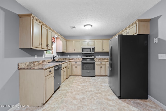103 Maggie Ln, Bardstown, KY 40004 - kitchen featuring appliances with stainless steel finishes, a sink, light brown cabinetry, baseboards, and a textured ceiling