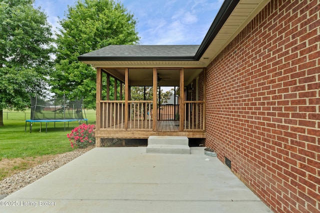 103 Maggie Ln, Bardstown, KY 40004 - wooden terrace featuring ceiling fan, a trampoline, a patio, and a lawn