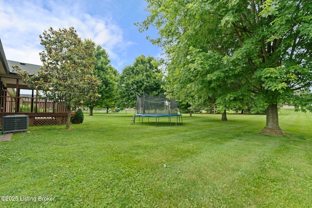 103 Maggie Ln, Bardstown, KY 40004 - view of grassy yard featuring a trampoline, central AC, and a deck