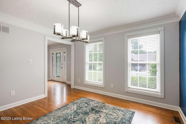 103 Deer Grove Ct, Elizabethtown, KY 42701 - unfurnished dining area featuring a chandelier, crown molding, wood finished floors, and baseboards