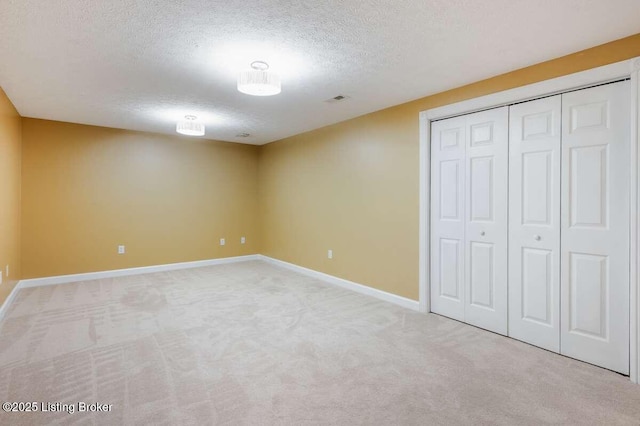 103 Deer Grove Ct, Elizabethtown, KY 42701 - unfurnished bedroom featuring a textured ceiling, light carpet, baseboards, and a closet