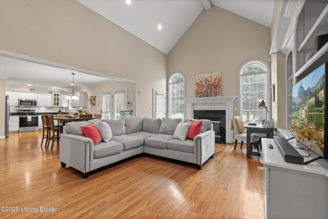 6209 Interlaken Way, Prospect, KY 40059 - living area with high vaulted ceiling, light wood-type flooring, a fireplace with flush hearth, recessed lighting, and beam ceiling
