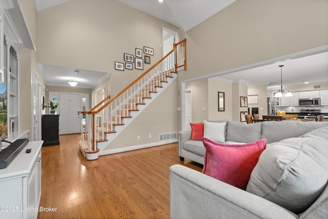 6209 Interlaken Way, Prospect, KY 40059 - living area with stairs, high vaulted ceiling, light wood-type flooring, ornamental molding, and baseboards
