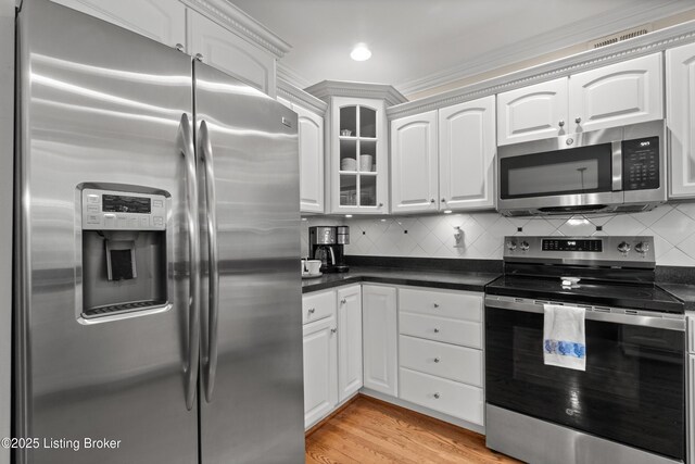 6209 Interlaken Way, Prospect, KY 40059 - kitchen featuring appliances with stainless steel finishes, dark countertops, white cabinets, and glass insert cabinets
