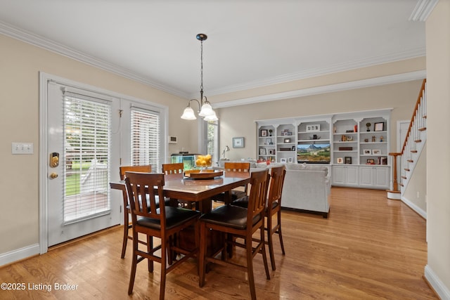 6209 Interlaken Way, Prospect, KY 40059 - dining area featuring ornamental molding, light wood-type flooring, baseboards, stairs, and a chandelier