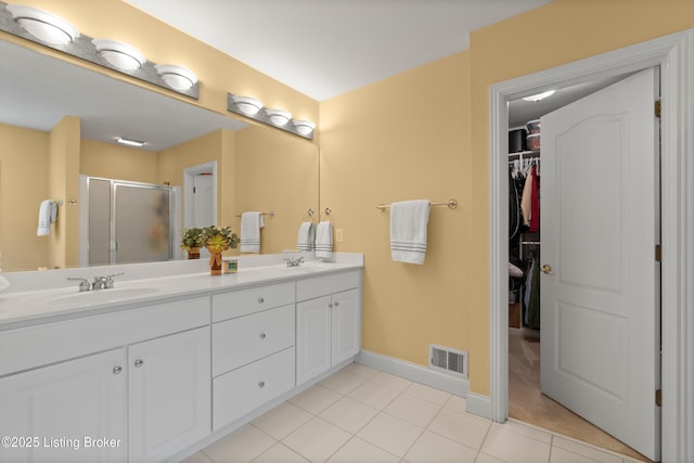 6209 Interlaken Way, Prospect, KY 40059 - full bath featuring a stall shower, double vanity, tile patterned flooring, a walk in closet, and baseboards