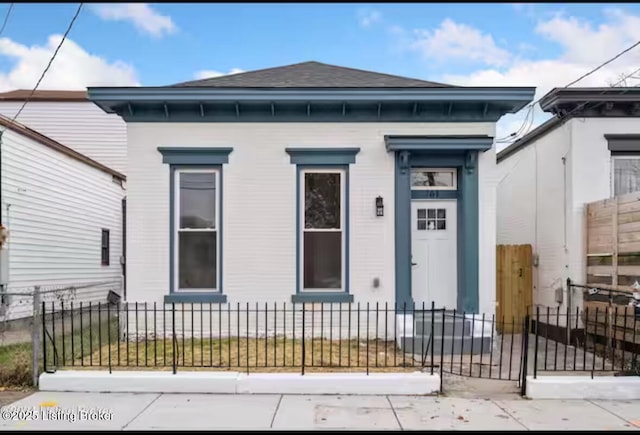 761 Logan St, Louisville, KY 40204 - view of front facade with a fenced front yard and a shingled roof