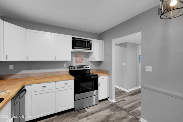 2300 Dundee Rd Unit 2, Louisville, KY 40205 - kitchen featuring electric stove, butcher block counters, black microwave, light wood-style flooring, and white cabinetry