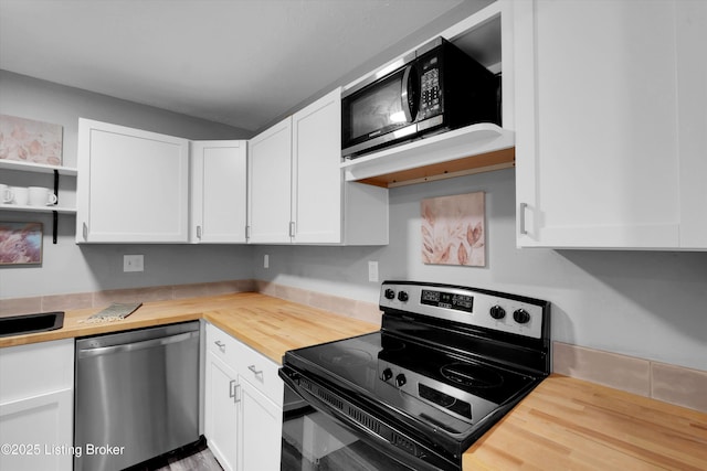 2300 Dundee Rd Unit 2, Louisville, KY 40205 - kitchen with dishwasher, range with electric stovetop, wood counters, black microwave, and white cabinets
