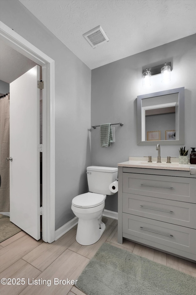 2300 Dundee Rd Unit 2, Louisville, KY 40205 - bathroom with vanity, toilet, wood finish floors, and baseboards