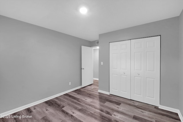2300 Dundee Rd Unit 2, Louisville, KY 40205 - unfurnished bedroom with wood finished floors, baseboards, and a closet