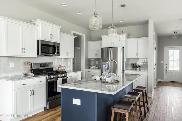 2824 Alder Wood Ln, La Grange, KY 40031 - kitchen featuring stainless steel appliances, white cabinetry, light stone counters, tasteful backsplash, and recessed lighting