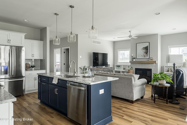 2824 Alder Wood Ln, La Grange, KY 40031 - kitchen with stainless steel appliances, a sink, white cabinetry, ceiling fan, and wood finished floors