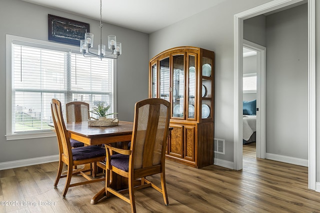 2824 Alder Wood Ln, La Grange, KY 40031 - dining area with a chandelier, wood finished floors, and baseboards