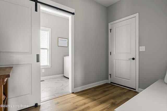 2824 Alder Wood Ln, La Grange, KY 40031 - laundry room featuring marble look tile flooring, baseboards, and a barn door