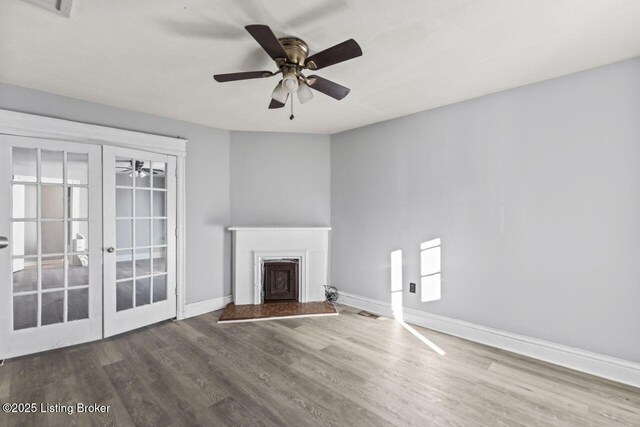 2733 Dumesnil St, Louisville, KY 40211 - unfurnished living room featuring wood finished floors, ceiling fan, french doors, and a fireplace