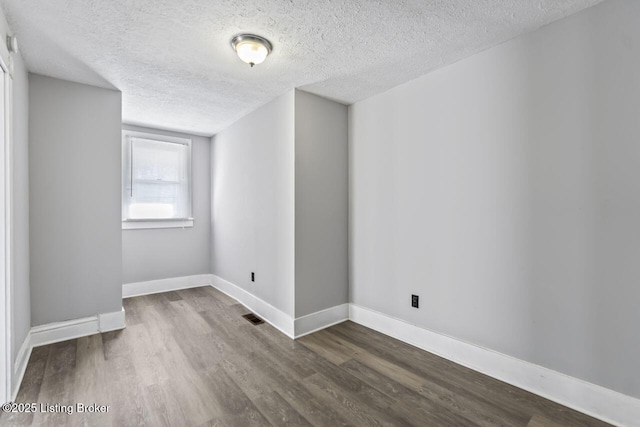 2733 Dumesnil St, Louisville, KY 40211 - unfurnished room featuring a textured ceiling and wood finished floors
