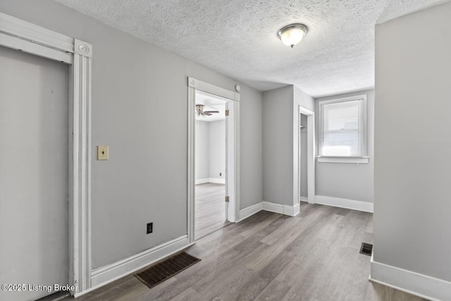 2733 Dumesnil St, Louisville, KY 40211 - unfurnished bedroom with wood finished floors and a textured ceiling