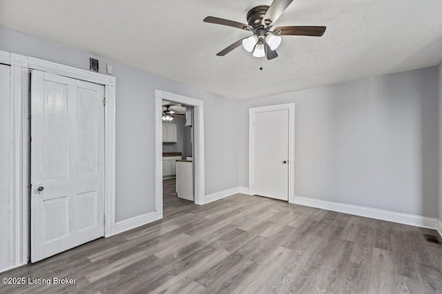 2733 Dumesnil St, Louisville, KY 40211 - unfurnished bedroom featuring wood finished floors, ensuite bathroom, and ceiling fan