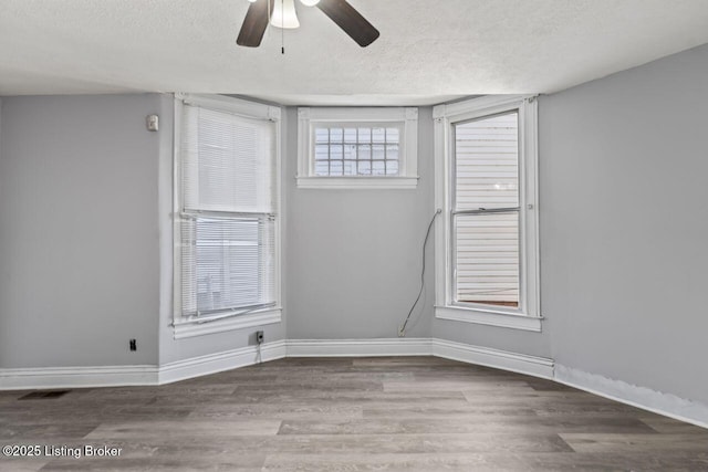 2733 Dumesnil St, Louisville, KY 40211 - empty room featuring a textured ceiling, a ceiling fan, and wood finished floors
