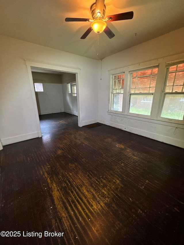 3 Eutropia Ct, Louisville, KY 40208 - unfurnished room featuring dark wood-type flooring, baseboards, and plenty of natural light