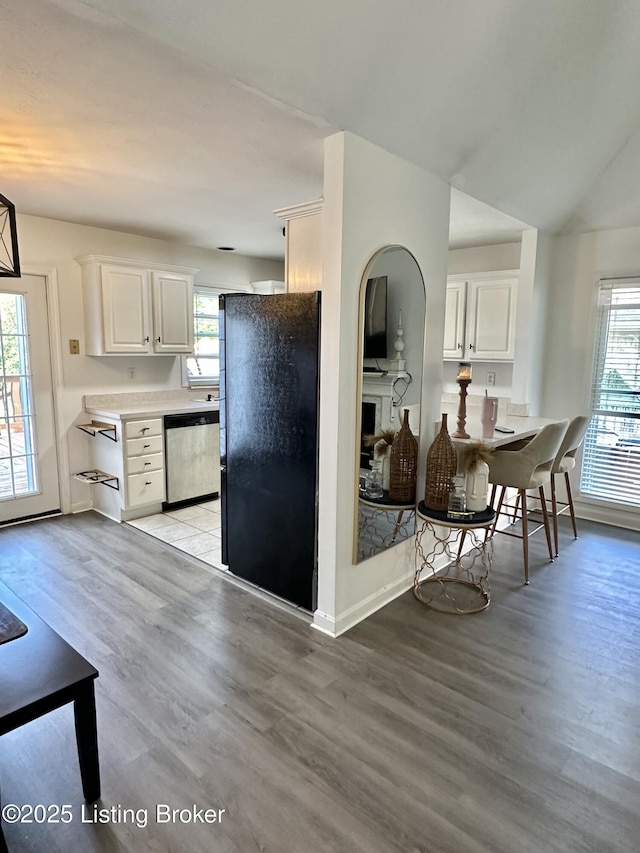 3907 Vantage Pl, Jeffersontown, KY 40299 - kitchen featuring stainless steel dishwasher, freestanding refrigerator, light wood-style floors, plenty of natural light, and vaulted ceiling