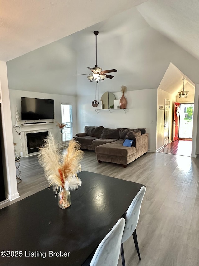3907 Vantage Pl, Jeffersontown, KY 40299 - dining area featuring vaulted ceiling, wood finished floors, a ceiling fan, a fireplace, and baseboards