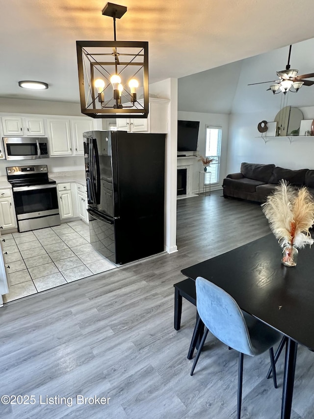 3907 Vantage Pl, Jeffersontown, KY 40299 - kitchen with appliances with stainless steel finishes, light wood-type flooring, open floor plan, white cabinetry, and light countertops