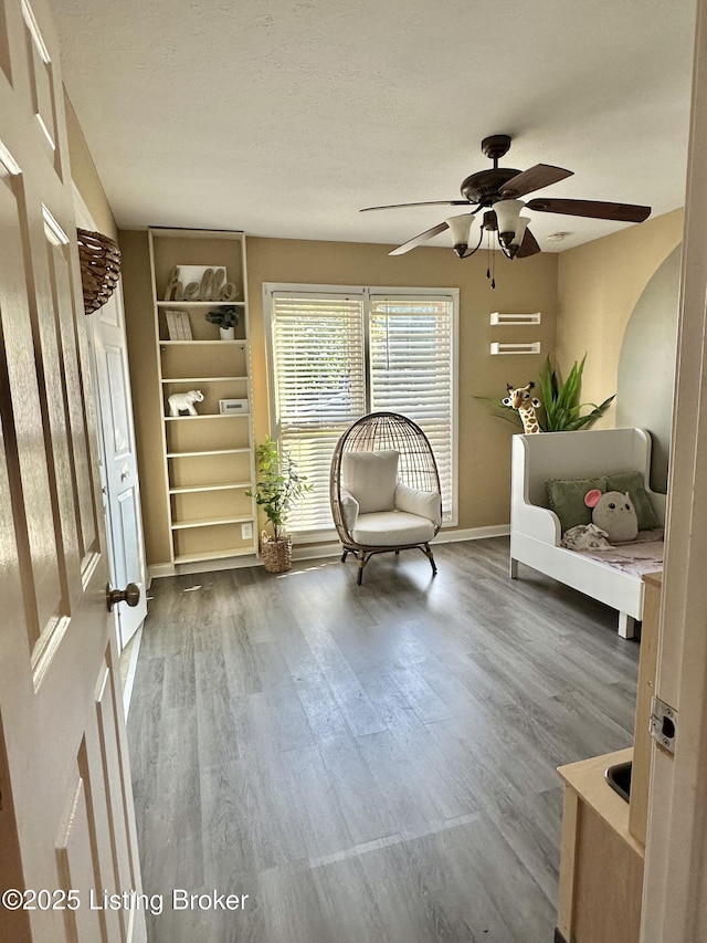 3907 Vantage Pl, Jeffersontown, KY 40299 - sitting room featuring a ceiling fan, wood finished floors, baseboards, and built in shelves
