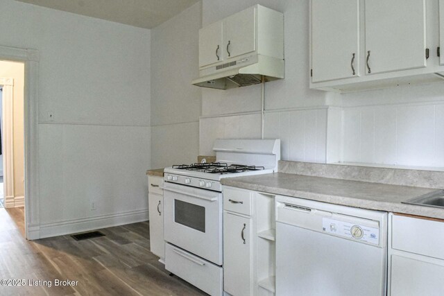 513 Camp St, Louisville, KY 40203 - kitchen with white appliances, under cabinet range hood, dark wood-type flooring, light countertops, and white cabinets