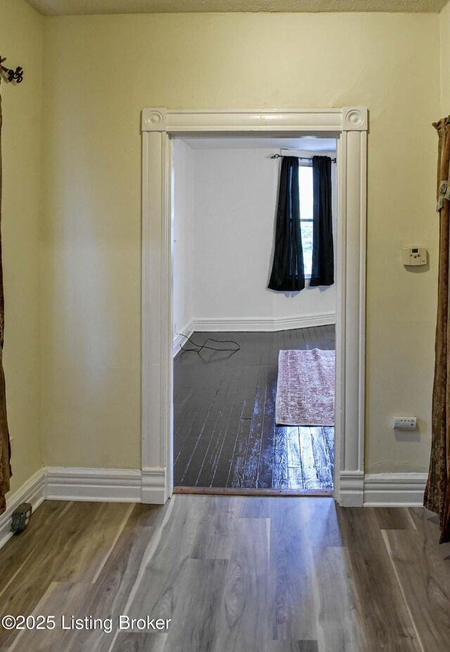 513 Camp St, Louisville, KY 40203 - spare room featuring wood finished floors and baseboards
