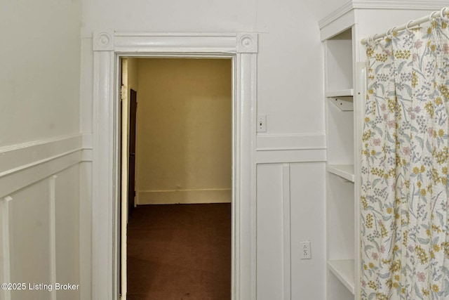 513 Camp St, Louisville, KY 40203 - corridor featuring a decorative wall, a wainscoted wall, and carpet