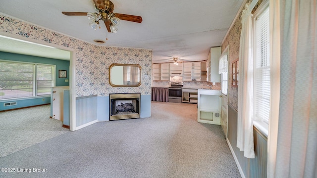 316 Short Rd, Louisville, KY 40207 - unfurnished living room featuring a ceiling fan, a fireplace, light carpet, wallpapered walls, and a sink