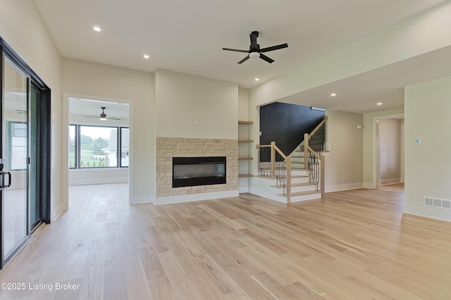 6609 Clore Lake Rd, Crestwood, KY 40014 - unfurnished living room with ceiling fan, stairway, a stone fireplace, light wood-type flooring, and recessed lighting