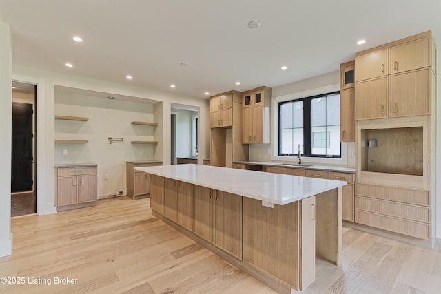 6609 Clore Lake Rd, Crestwood, KY 40014 - kitchen with light brown cabinetry, light wood-style floors, open shelves, recessed lighting, and a center island