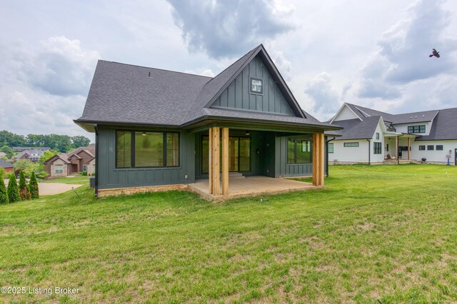 6609 Clore Lake Rd, Crestwood, KY 40014 - rear view of house with board and batten siding, a patio, a lawn, and a shingled roof