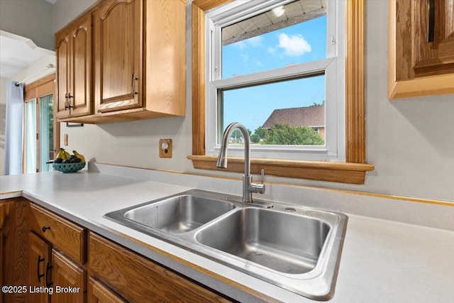 7419 Beahl Blvd, Louisville, KY 40258 - kitchen featuring brown cabinetry, light countertops, and healthy amount of natural light