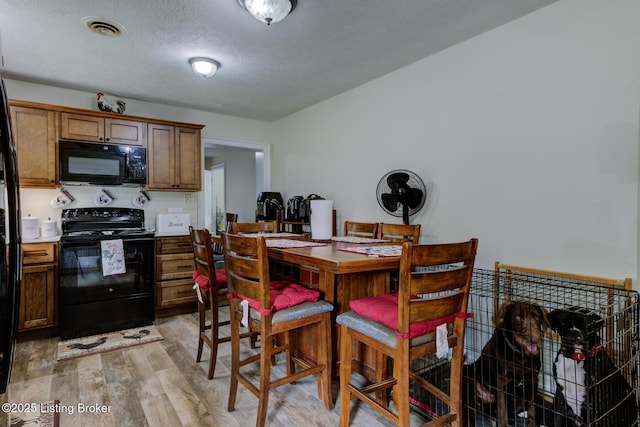 14499 S S Highway 259, Leitchfield, KY 42754 - dining area with light wood-style flooring and a textured ceiling