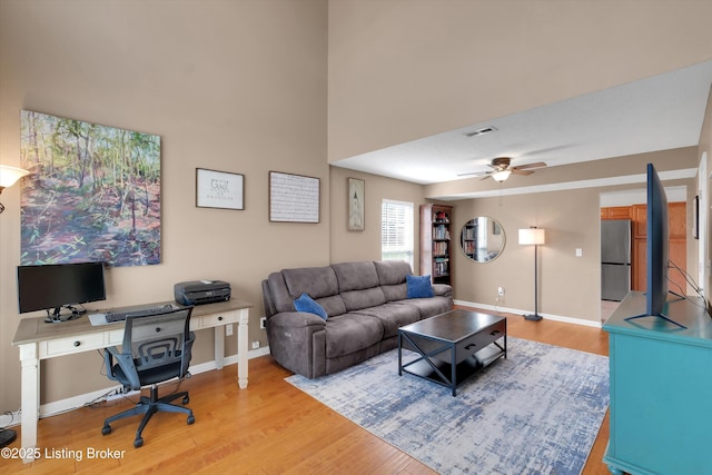 204 Greenleaf Dr, Elizabethtown, KY 42701 - living area featuring light wood finished floors, baseboards, a ceiling fan, and a desk