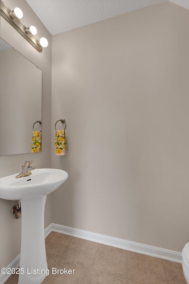 204 Greenleaf Dr, Elizabethtown, KY 42701 - bathroom with baseboards, tile patterned floors, toilet, and a sink