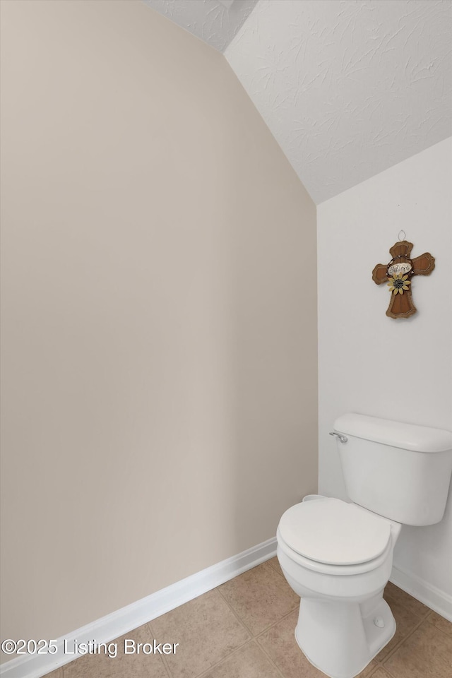 204 Greenleaf Dr, Elizabethtown, KY 42701 - bathroom with vaulted ceiling, toilet, baseboards, tile patterned flooring, and a textured ceiling