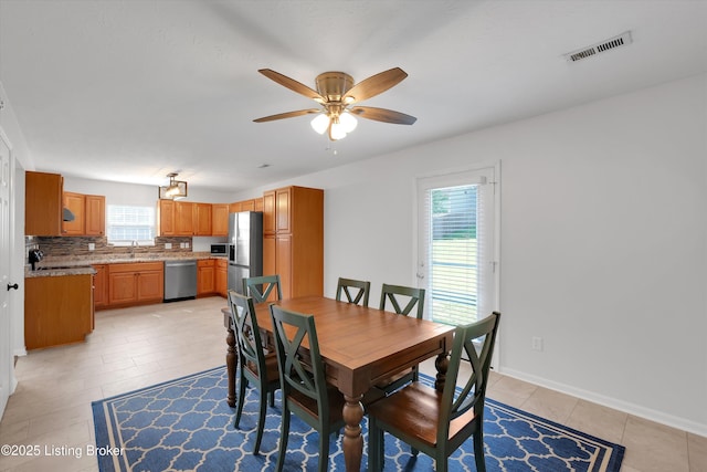 204 Greenleaf Dr, Elizabethtown, KY 42701 - dining room with healthy amount of natural light, a ceiling fan, light tile patterned floors, and baseboards