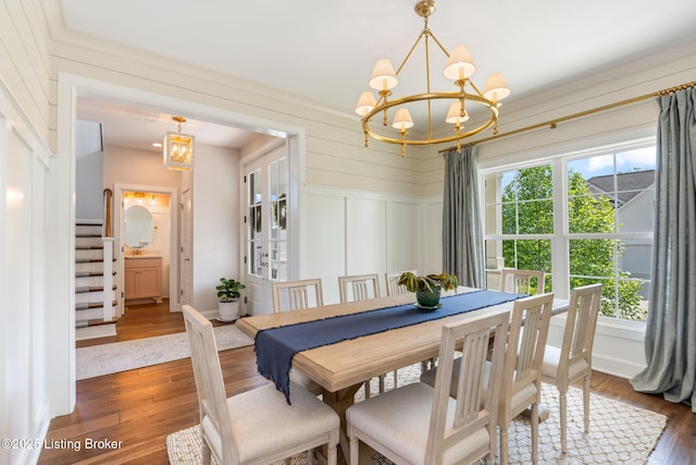 17716 Shakes Creek Dr, Fisherville, KY 40023 - dining area featuring a chandelier, dark wood-type flooring, a decorative wall, stairs, and ornamental molding