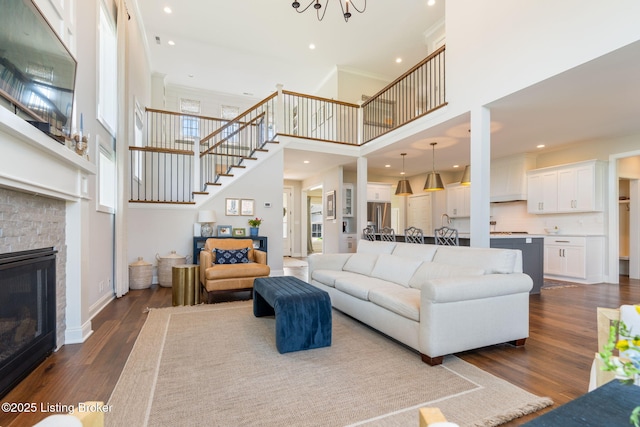 17716 Shakes Creek Dr, Fisherville, KY 40023 - living room featuring stairs, a high ceiling, dark wood finished floors, recessed lighting, and a chandelier