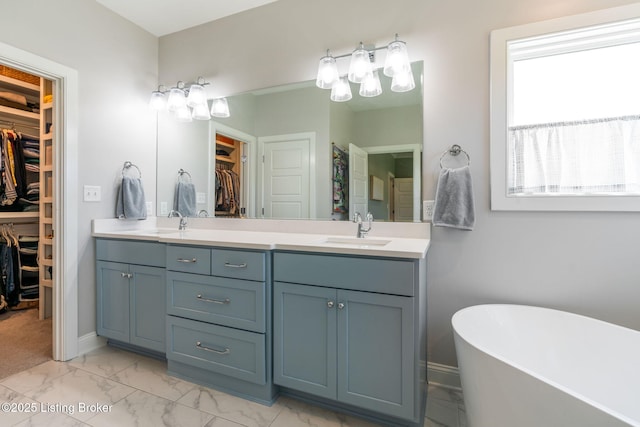 17716 Shakes Creek Dr, Fisherville, KY 40023 - bathroom with a spacious closet, double vanity, marble look tile flooring, and a freestanding tub