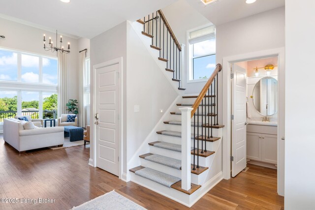 17716 Shakes Creek Dr, Fisherville, KY 40023 - stairway featuring wood finished floors, a chandelier, recessed lighting, and a high ceiling